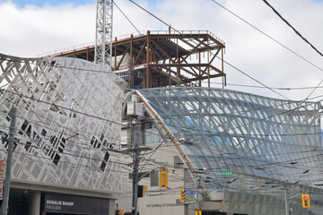 Naklejka premium OCAD Rosalie Sharp Pavilion (115 McCaul St) contrast with Frank Gehry Galleria Italia canopy at the Art Gallery of Ontario, 317 Dundas St W, Toronto