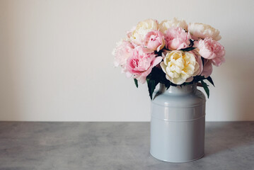 Beautiful bouquet of fresh colorful peonies in full bloom in vase. Floral spring still life. Copy space for text. © Iryna