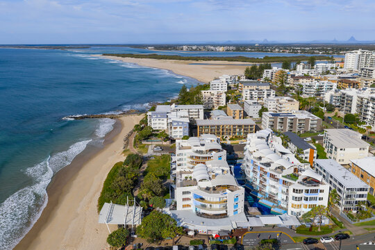 Aerial view of highrise apartments along a beach and waterfront