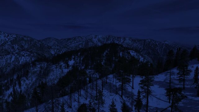Night Snowcrest Aerial Shot of Winter Snow Forest Road Forward Reveal Day for Night