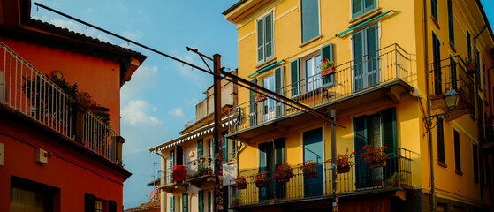 Obraz premium Bellagio village at lake Como near Milan Italy, region Lombardy. Famous street with paving stones stairs and cosy restaurants during sunrise with glowing lanterns and green plants on old houses walls.