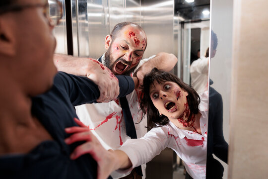 Man getting bit by supernatural occult zombies in elevator trying to infect him. Diseased bloody monsters in office building chomping on victim flesh during apocalyptical virus outbreak