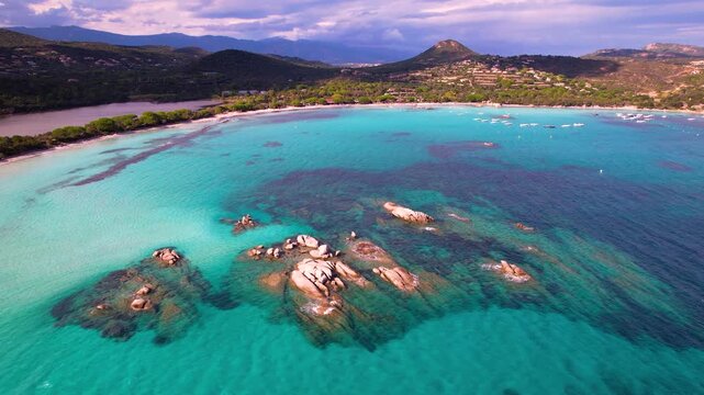 Corsica Santa Giulia beach aerial drone flight over turquoise sea and yellow rocks France 4k travel destination exotic island scenery, tropics in europe