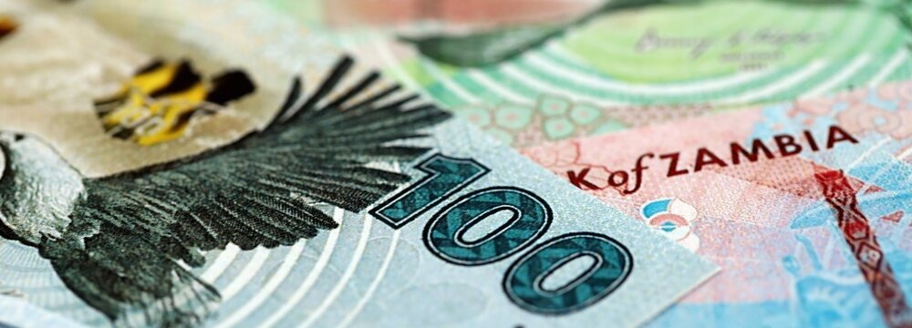 Zambian kwacha money bills pile on table. Zambia banknotes of ZMW currency close up. Concept of business, economy and banking in Zambia