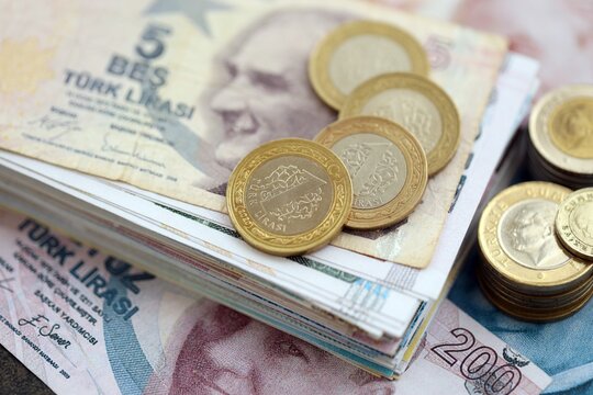 Turkish lira money bills and kurus coins pile on table. Turkey coins on banknotes of TRY currency close up. Concept of business, taxes and banking in Turkey