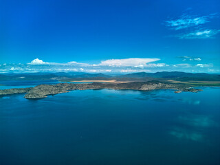 Obraz premium Aerial view of the vast Bukhtarma Reservoir with deep blue water and mountains in Kazakhstan