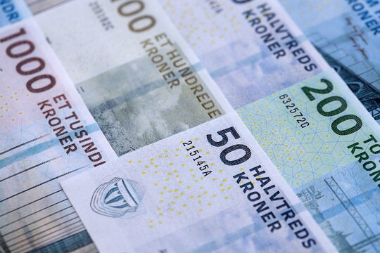 Danish krone paper banknotes pile on table. Denmark DKK currency money bills in big amount. Concept of economics, taxation and banking in Denmark