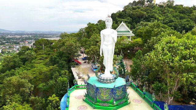 SI RACHA, THAILAND - MARCH 17, 2026: Aerial view of Samnaksong Khao Phra Khru Buddhist temple and monastery located on a hilltop overlooking the city.