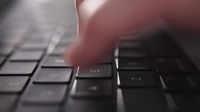 Hands typing on laptop keyboard in modern office interior. Productivity and corporate concept.
