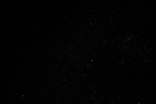 Grunge overlay effect with scratch and dust on black. background, retro noisy grain dust texture for film or photo overlay, old photo overlay texture, black grainy background