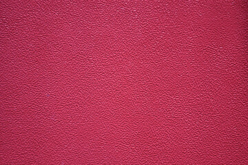 Fototapeta premium Pink textured paper substrate backdrop with fibrous material and coarse grain pattern. The high-resolution surface features a natural distressed matte finish, ideal for minimalist graphic designs