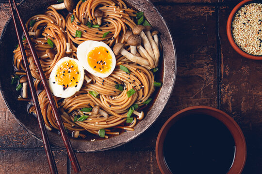 buckwheat noodles, soba, with shimeji mushrooms, boiled egg, green onion, sesame seeds, homemade, no people,