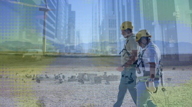 Two site techs walking rubble, one glancing and checking harness safely, urban overlay appearing