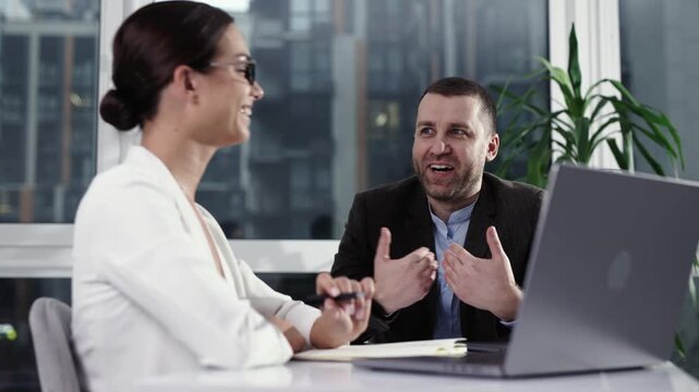 Businesswoman entrepreneur conducting job interview with male candidate in modern office. Recruitment and hiring concept.
