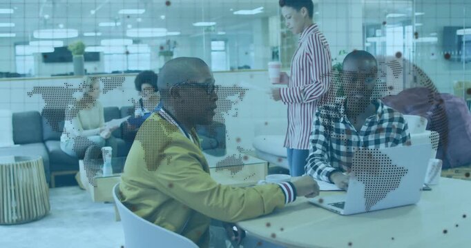 Bald man gesturing, peer following typing on laptop while dotted map passing front, supporting tech