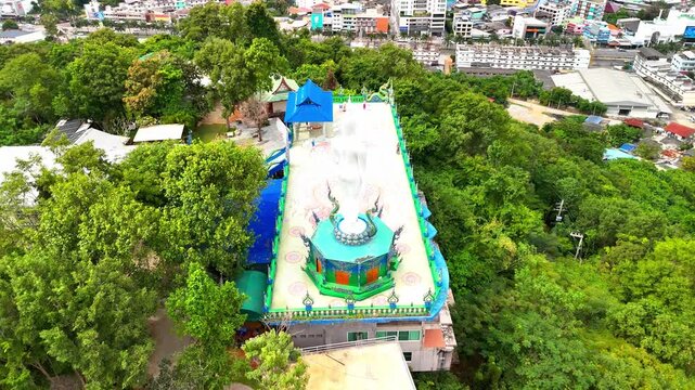 SI RACHA, THAILAND - MARCH 17, 2026: Aerial view of Samnaksong Khao Phra Khru Buddhist temple and monastery located on a hilltop overlooking the city.