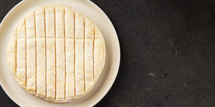 Soft cheese Camembert, Brie, or Coulommiers cheese head tasty snack fresh gourmet food background on the table rustic food top view copy space marketing concept photo