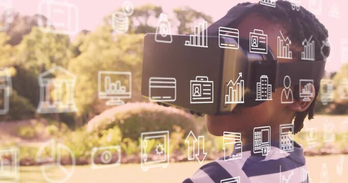 Boy wearing VR headset in park, finance icons appearing and sparking exploration while adjusting