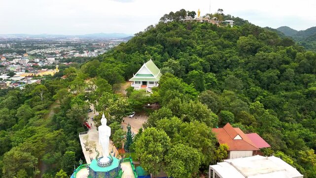 SI RACHA, THAILAND - MARCH 17, 2026: Aerial view of Samnaksong Khao Phra Khru Buddhist temple and monastery located on a hilltop overlooking the city.