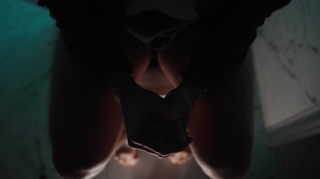 Top View, a Man at Night on the Toilet Writhes in Pain. Concept of Poisoning or Other Illnesses.