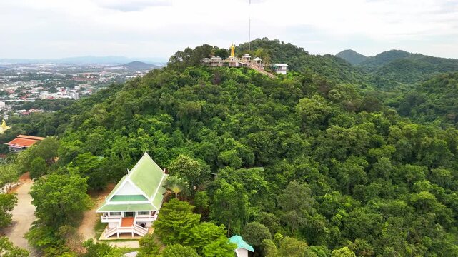 SI RACHA, THAILAND - MARCH 17, 2026: Aerial view of Samnaksong Khao Phra Khru Buddhist temple and monastery located on a hilltop overlooking the city.