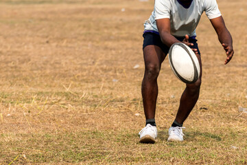 Rugby player caching a ball during training © suman