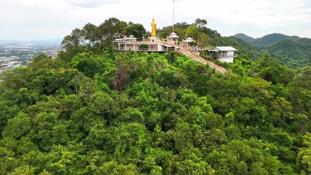 SI RACHA, THAILAND - MARCH 17, 2026: Aerial view of Samnaksong Khao Phra Khru Buddhist temple and monastery located on a hilltop overlooking the city.