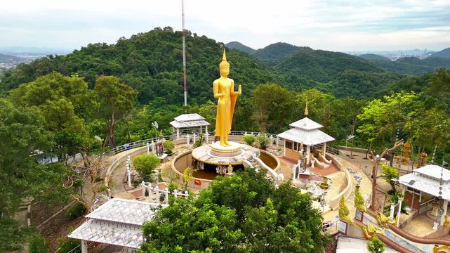 SI RACHA, THAILAND - MARCH 17, 2026: Aerial view of Samnaksong Khao Phra Khru Buddhist temple and monastery located on a hilltop overlooking the city.