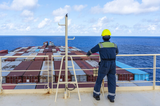 Marine mechanic on board of a commercial shipping vessel, global transport concept.	