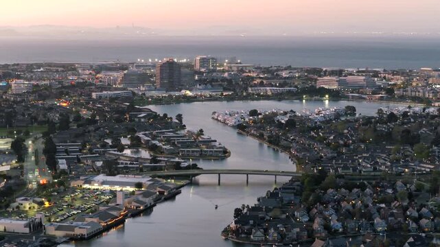 Foster City CA - Aerial Rotation of Waterway and Cars on Bridge at Dusk