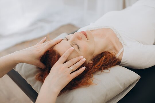 Woman receiving theta healing session for wellness