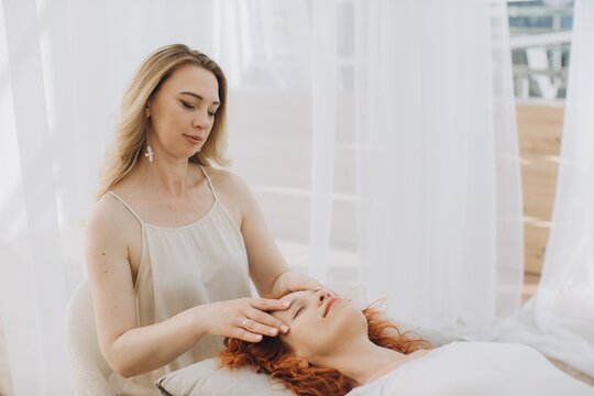 Woman practicing theta healing therapy session on client