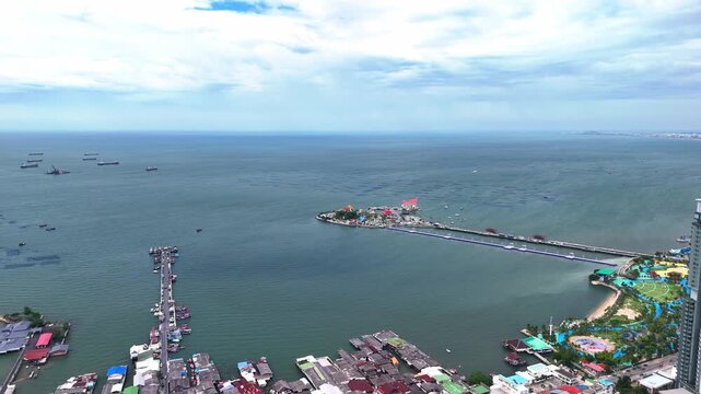 Drone flying over the urban landscape and coastal cityscape of Si Racha, Gulf of Thailand.