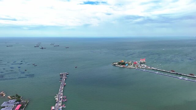 Drone flying over the urban landscape and coastal cityscape of Si Racha, Gulf of Thailand.