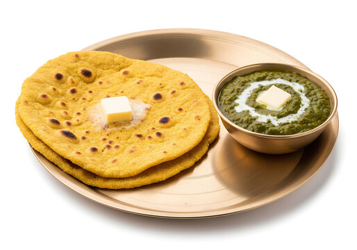 Stack of two Makki ki Roti corn flatbreads with butter served alongside a bowl of Sarson ka Saag mustard greens, popular Punjabi winter delicacy and authentic healthy vegetarian meal.
