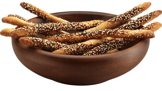 Pile of dark breadsticks covered in black and white sesame seeds in a dark brown wooden bowl, tasty snack, studio lighting, transparent background