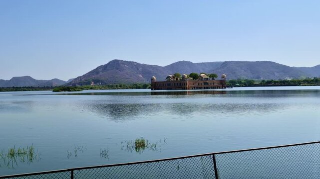 The majestic Jal Mahal sits peacefully in the middle of Man Sagar Lake, surrounded by the Aravalli hills. Iconic Water Palace showcases stunning Rajput architecture against a calm Jaipur skyline.