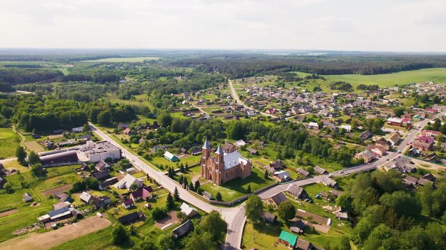 Aerial view of a red brick church in a small european town