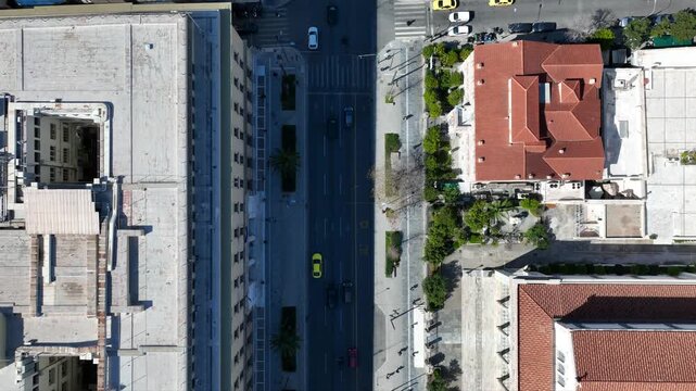 Aerial drone top down cinematic video of Athens centre dense urban landmark buildings near area of Syntagma square and Athens neoclassic trilogy in Panepistimiou street, Attica, Greece