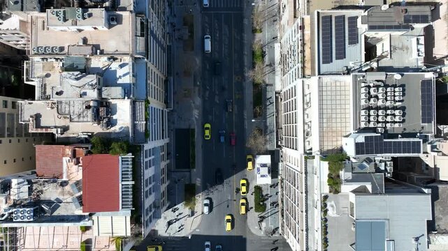 Aerial drone top down cinematic video of Athens centre dense urban landmark buildings near area of Syntagma square and Athens neoclassic trilogy in Panepistimiou street, Attica, Greece