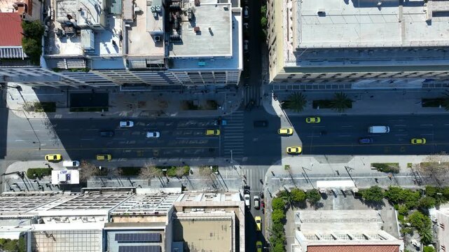 Aerial drone top down cinematic video of Athens centre dense urban landmark buildings near area of Syntagma square and Athens neoclassic trilogy in Panepistimiou street, Attica, Greece