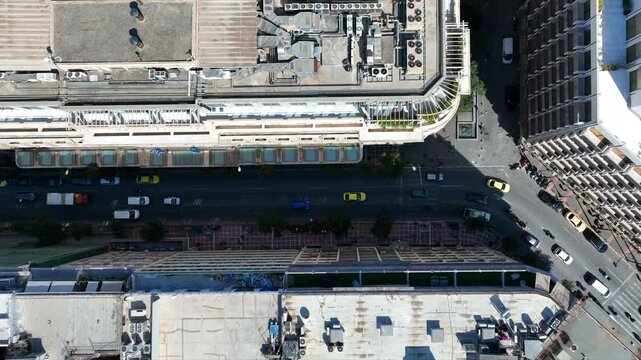 Aerial drone top down cinematic video of Athens centre dense urban landmark buildings near area of Syntagma square and Athens neoclassic trilogy in Panepistimiou street, Attica, Greece