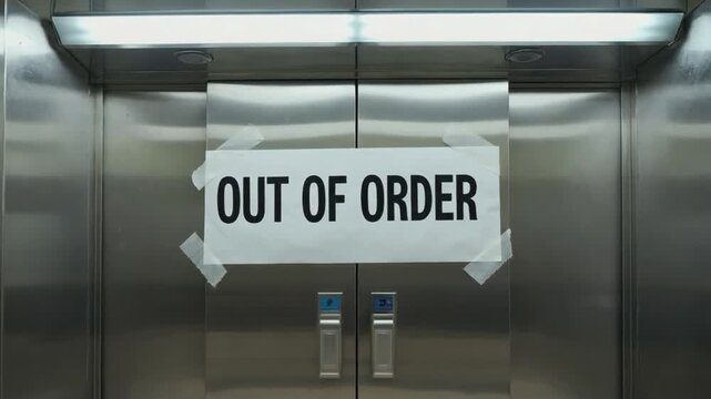 "Out of order" sign in an elevator.