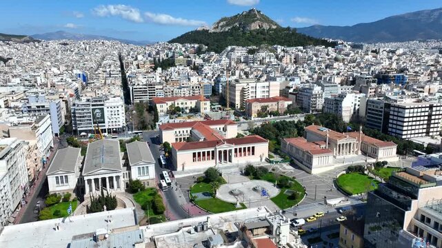 Aerial drone cinematic video of the Neoclassical Trilogy buildings , the National Library, the old University of and the Academy of Athens on Panepistimiou str., Athens historic centre, Attica, Greece