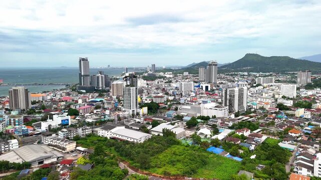 Drone flying over the urban landscape and coastal cityscape of Si Racha, Gulf of Thailand.