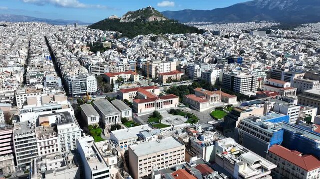 Aerial drone cinematic video of the Neoclassical Trilogy buildings , the National Library, the old University of and the Academy of Athens on Panepistimiou str., Athens historic centre, Attica, Greece