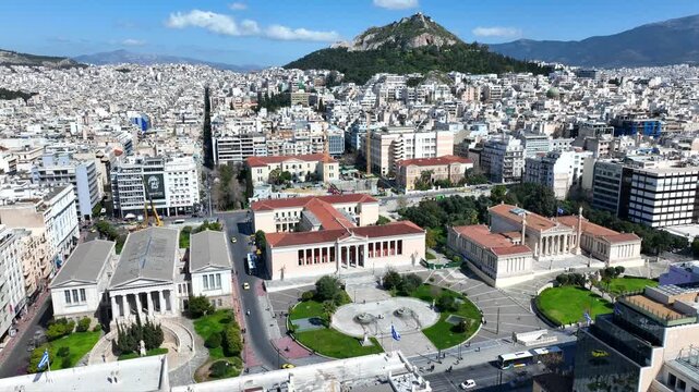 Aerial drone cinematic video of the Neoclassical Trilogy buildings , the National Library, the old University of and the Academy of Athens on Panepistimiou str., Athens historic centre, Attica, Greece