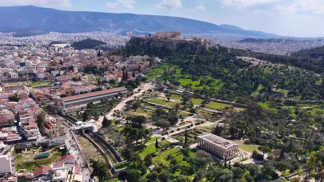Aerial drone cinematic video of Ancient Agora or Forum of Athens historic centre built below Acropolis hill, Attica, Greece