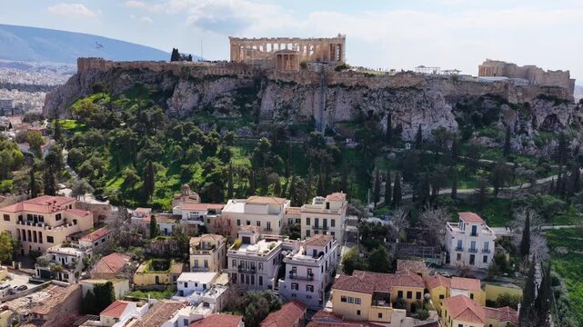 Aerial drone cinematic video of picturesque Plaka district Anafiotika and a flyover Acropolis hill in the heart of Athens historic centre, Attica, Greece