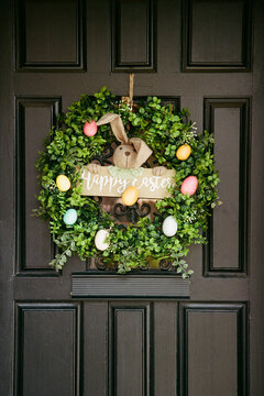 Wreath on a front door showing a bunny and Easter eggs during the spring season